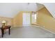This bonus room has neutral walls and carpet and features attic storage at 2740 Cameron Commons Way, Matthews, NC 28104