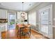 Charming breakfast nook features a wooden table, pendant lighting, and direct access to outdoor patio at 2740 Cameron Commons Way, Matthews, NC 28104