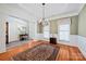 Well-lit dining room with hardwood floors, decorative molding, and classic window treatments for a refined atmosphere at 2740 Cameron Commons Way, Matthews, NC 28104