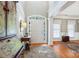 Bright foyer with hardwood floors, transom windows over the door, and elegant architectural details at 2740 Cameron Commons Way, Matthews, NC 28104