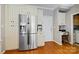 Modern kitchen includes stainless steel refrigerator, custom cabinetry and provides access to laundry room at 2740 Cameron Commons Way, Matthews, NC 28104