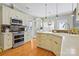 Well-appointed kitchen boasts stainless steel appliances, granite countertops, white cabinetry, and ample counter space at 2740 Cameron Commons Way, Matthews, NC 28104