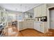 Bright kitchen featuring white cabinetry, granite countertops, stainless steel appliances, and breakfast nook access at 2740 Cameron Commons Way, Matthews, NC 28104
