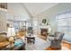 Bright living room features a fireplace, vaulted ceiling, and hardwood floors with an open view to the kitchen at 2740 Cameron Commons Way, Matthews, NC 28104