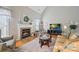 Cozy living room with a fireplace, vaulted ceiling, and comfortable seating, perfect for relaxation at 2740 Cameron Commons Way, Matthews, NC 28104