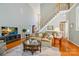 Spacious living room featuring high ceilings, staircase, and large windows offering abundant natural light at 2740 Cameron Commons Way, Matthews, NC 28104