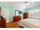 Light-filled main bedroom features a tray ceiling, hardwood floors, and ensuite bathroom at 2740 Cameron Commons Way, Matthews, NC 28104
