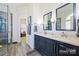 This primary bath offers a double sink vanity, granite countertops, and a glass shower at 2740 Cameron Commons Way, Matthews, NC 28104