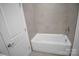 Clean bathroom with a new white bathtub and tiled walls at 3054 Constitution Ln, Gastonia, NC 28056