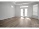 Well-lit bedroom with hardwood floors, backyard access, and modern trim at 3054 Constitution Ln, Gastonia, NC 28056