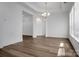 Spacious dining room with hardwood floors and a modern chandelier fixture at 3054 Constitution Ln, Gastonia, NC 28056