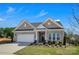 Inviting single-story home with a manicured lawn and attached two-car garage at 3054 Constitution Ln, Gastonia, NC 28056