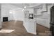 Open-concept kitchen with white cabinets, stainless appliances, and a fireplace in the next room at 3054 Constitution Ln, Gastonia, NC 28056