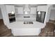 Gourmet kitchen features white cabinetry, stainless steel appliances, and a large island at 3054 Constitution Ln, Gastonia, NC 28056
