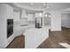 Gourmet kitchen features white cabinetry, stainless steel appliances, and a large island at 3054 Constitution Ln, Gastonia, NC 28056
