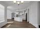 Open-concept kitchen with white cabinets, stainless appliances, and a fireplace in the next room at 3054 Constitution Ln, Gastonia, NC 28056
