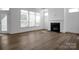 Bright, open-concept living room with hardwood floors and a modern fireplace at 3054 Constitution Ln, Gastonia, NC 28056