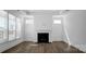 Bright living room features a fireplace, hardwood floors, and natural light from large windows at 3054 Constitution Ln, Gastonia, NC 28056