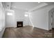 Bright living room features a fireplace, hardwood floors, and natural light from large windows at 3054 Constitution Ln, Gastonia, NC 28056
