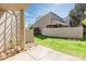 Backyard of property has privacy fence, green lawn and trellised accents at 3709 Willow Point Dr, Charlotte, NC 28277