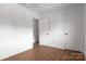 An empty bedroom with a ceiling fan, wood floors, white trim and plenty of wall space at 3709 Willow Point Dr, Charlotte, NC 28277