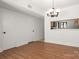 Dining room area with hardwood floors, hanging light fixture, and opening to the kitchen at 3709 Willow Point Dr, Charlotte, NC 28277