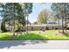 Well maintained property with mature landscaping and sprawling green lawn at 3709 Willow Point Dr, Charlotte, NC 28277