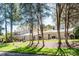 A view of the townhome community featuring lush lawn and mature trees on a sunny day at 3709 Willow Point Dr, Charlotte, NC 28277