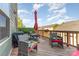 Relaxing deck features comfortable seating, umbrella, and scenic views of the neighborhood at 3718 Speer Blvd, Charlotte, NC 28217