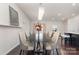 Spacious dining room with modern chandelier, stylish chairs, and hardwood floors at 3718 Speer Blvd, Charlotte, NC 28217