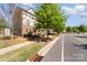 Attractive townhomes with colorful exteriors and street view, lined with sidewalks at 3718 Speer Blvd, Charlotte, NC 28217