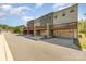Exterior of multi-level townhome with private decks and garages in a neighborhood setting at 3718 Speer Blvd, Charlotte, NC 28217