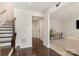 Bright and open foyer with dark hardwood floors, staircase, and view into the living area at 3718 Speer Blvd, Charlotte, NC 28217