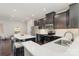 Stylish kitchen boasts stainless steel appliances, dark cabinets, and a white island with barstool seating at 3718 Speer Blvd, Charlotte, NC 28217