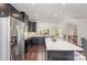 Bright, open kitchen with stainless appliances, dark wood floors, and a center island with seating at 3718 Speer Blvd, Charlotte, NC 28217