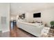 Bright, open-concept living room with sleek white sofa and hardwood floors at 3718 Speer Blvd, Charlotte, NC 28217