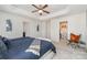 Spacious main bedroom with tray ceiling and a large walk-in closet filled with clothes at 3718 Speer Blvd, Charlotte, NC 28217