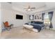 Spacious main bedroom with tray ceiling, sitting area, stylish curtains, and a large bed at 3718 Speer Blvd, Charlotte, NC 28217