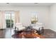 Cozy sitting area with two chairs, accent rug, and sliding glass doors to balcony at 3718 Speer Blvd, Charlotte, NC 28217