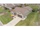 An elevated view of a well-maintained property featuring green lawn, a brown roof and driveway and landscaping at 423 Granite Lake Ct, Denver, NC 28037