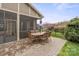 An exterior patio featuring an outdoor dining table and an outdoor kitchen/bar offers backyard entertainment at 423 Granite Lake Ct, Denver, NC 28037