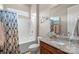 Bright bathroom featuring a tub with shower and a vanity with a granite countertop at 423 Granite Lake Ct, Denver, NC 28037