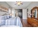 Well-lit bedroom boasts hardwood floors, an en suite bathroom, and a stylish barn door for added charm at 423 Granite Lake Ct, Denver, NC 28037