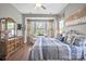 Bright bedroom features large windows, stylish decor, and a relaxing sitting area, with hardwood floors at 423 Granite Lake Ct, Denver, NC 28037