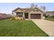 Charming single-story home featuring well-manicured lawn, brown garage door and an inviting front porch with yellow bushes at 423 Granite Lake Ct, Denver, NC 28037