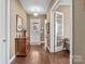 Bright foyer with beautiful hardwood floors, an antique wooden sideboard, and a decorative front door at 423 Granite Lake Ct, Denver, NC 28037