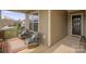 Inviting covered front porch with comfortable seating, a small rug, and a view of the neighborhood at 423 Granite Lake Ct, Denver, NC 28037