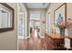 Hallway with wooden floors, white trim, neutral paint and views to other rooms in the home at 423 Granite Lake Ct, Denver, NC 28037