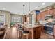 Well-lit kitchen with stainless steel appliances, granite countertops, an island with bar seating, and views to the dining area at 423 Granite Lake Ct, Denver, NC 28037