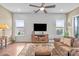Bright living room with large windows, ship lap accent wall, and comfortable seating at 423 Granite Lake Ct, Denver, NC 28037
